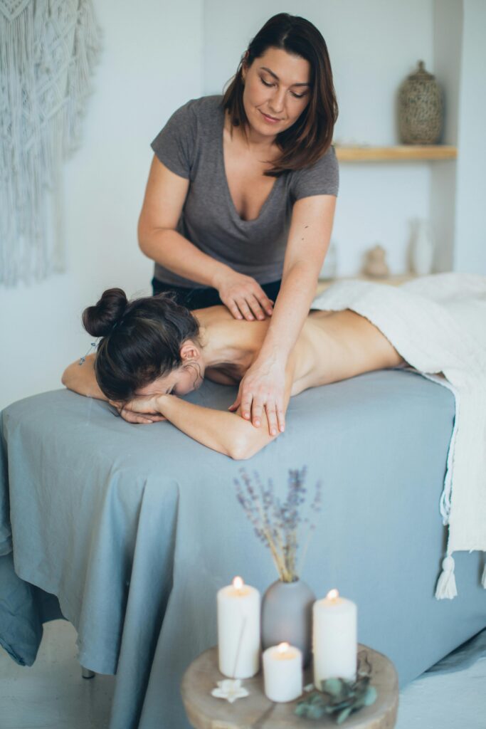 pexels-photo-3865792-3865792 A serene spa setting with a therapist giving a back massage to a female client for relaxation.